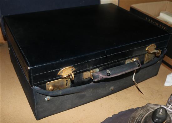 George V black leather dressing case with canvas outer cover, fitted Leins & Sons six-piece silver-mounted toilet set